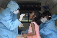 Nhân viên y tế lấy mẫu xét nghiệm nCoV cho một bé gái tại thành phố Chennai, Ấn Độ, hôm 16/6. Ảnh: AFP.