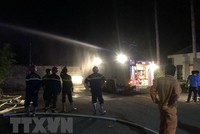 Lực lượng chức năng triển khai các biện pháp dập tắt đám cháy. (Ảnh: Đậu Tất Thành/TTXVN).
