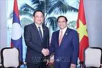 Thủ tướng Phạm Minh Chính gặp Thủ tướng Lào Sonexay Siphandone. Ảnh: Dương Giang/TTXVN