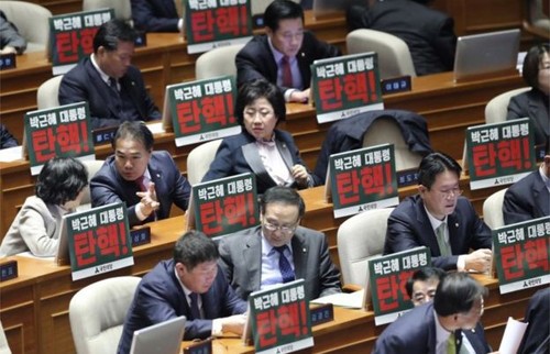 Các nghị sĩ đối lập trong quốc hội Hàn Quốc giương bảng có dòng chữ "Luận tội Tổng thống Park Geun-hye. Ảnh: AP