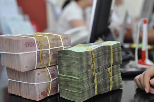Theo lãnh đạo Ngân hàng Nhà nước, dù đồng tiền các nước trong khu vực, thế giới chịu sự rung lắc mạnh trước những diễn biến khó lường của kinh tế thế giới, nhưng tiền Việt Nam năm qua chỉ mất giá nhẹ. Ảnh: Anh Quân