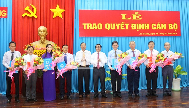 Phó Chủ tịch UBND tỉnh Anh Giang Lê Văn Nưng (thứ 5 bên trái) trao quyết định và tặng hoa cho các cán bộ được điều động, bổ nhiệm.