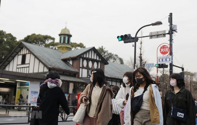 Người dân đeo khẩu trang phòng tránh lây nhiễm dịch COVID-19 tại Tokyo, Nhật Bản. (Ảnh: THX/TTXVN).