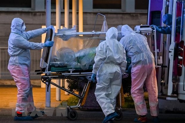 Nhân viên y tế chuyển bệnh nhân nhiễm COVID-19 tới bệnh viện ở Rome, Italy, ngày 16/3/2020. (Nguồn: AFP/TTXVN).