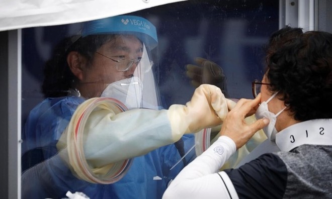 Người phụ nữ được lấy mẫu xét nghiệm nCoV tại một phòng khám dã chiến ở Seoul, Hàn Quốc, ngày 26/8. Ảnh: Reuters.