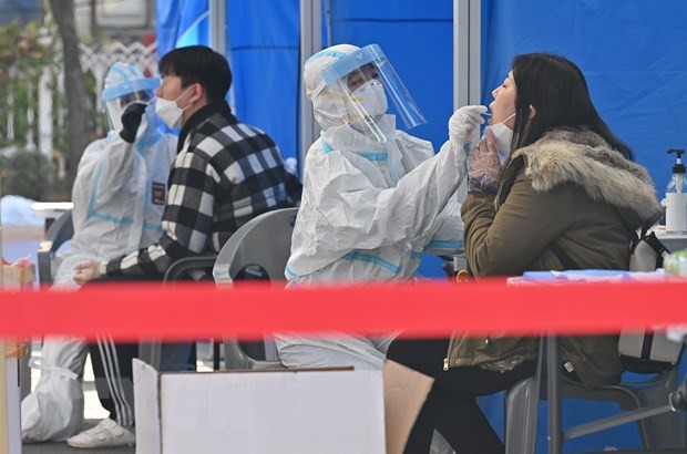 Nhân viên y tế lấy mẫu xét nghiệm COVID-19 cho người dân tại Seoul, Hàn Quốc ngày 27/11/2020. (Ảnh: AFP/TTXVN).