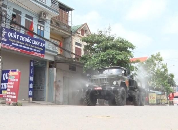 Lực lượng quân đội tiến hành phun khử khuẩn đường phố thị xã Mỹ Hào. (Ảnh: Đinh Tuấn/TTXVN).