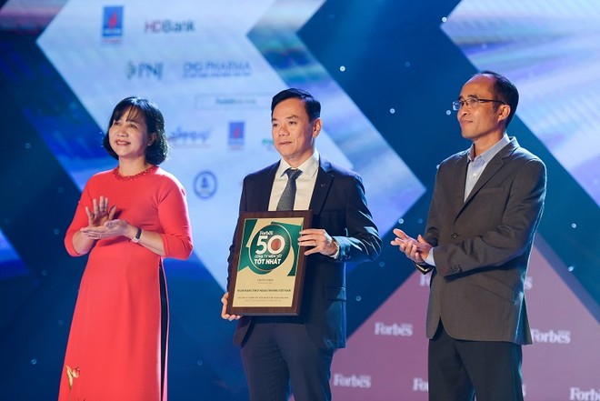 Đại diện Vietcombank, ông Đặng Hoài Đức – Phó Tổng Giám đốc Vietcombank kiêm Trưởng Văn phòng đại diện khu vực Phía Nam (đứng giữa) nhận giải thưởng do Tạp chí Forbes Việt Nam trao tặng
