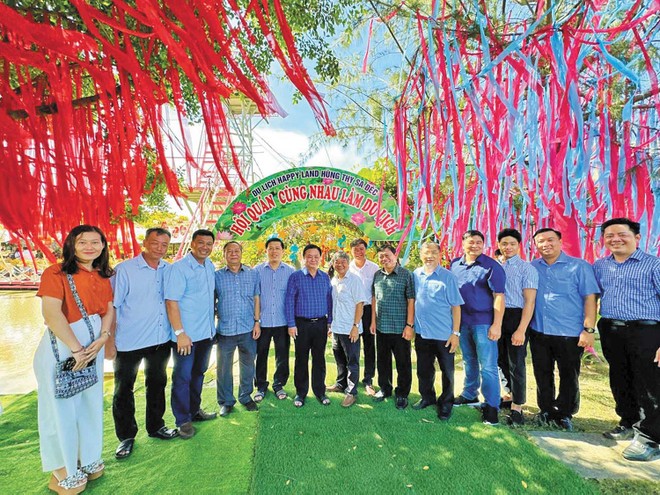 Bộ trưởng Lê Minh Hoan (thứ 6 từ trái qua) và lãnh đạo tỉnh khảo sát mô hình Hội quán Cùng nhau làm du lịch