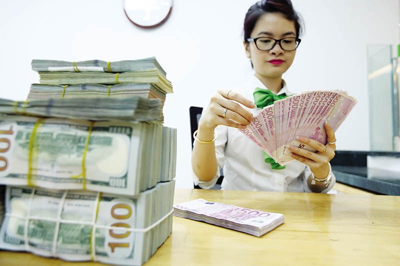 Việt Nam có nhiều lợi thế để ổn định tỷ giá, như xuất siêu ở mức cao, dự trữ ngoại hối và nguồn kiều hối lớn… Ảnh: Đ.T 
