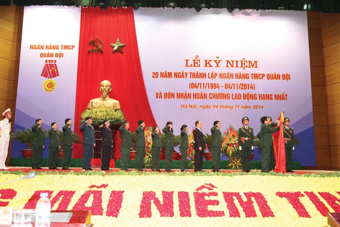 Đại tướng Phùng Quang Thanh - Ủy viên Bộ Chính trị, Phó Bí thư Quân ủy Trung ương, Bộ trưởng Bộ Quốc phòng gắn Huân chương Lao động hạng Nhất lên Quân kỳ Quyết thắng