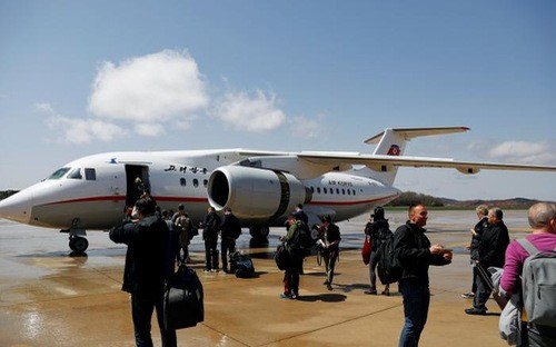 Hành khách chuẩn bị lên một máy bay của Air Koryo ở sân bay Bình Nhưỡng hôm 18/4 - Ảnh: Reuters.