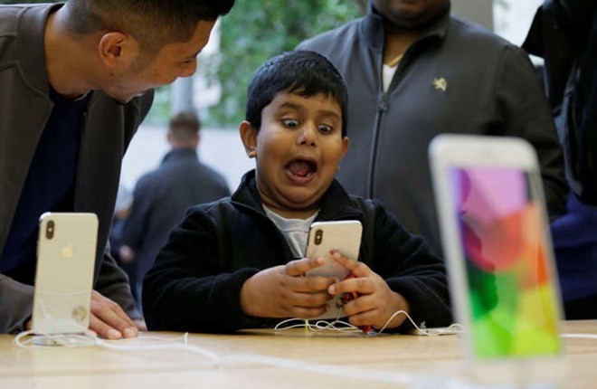 Một cậu bé phấn khích với tính năng aniemoji trên iPhone X. (Nguồn: AFP)