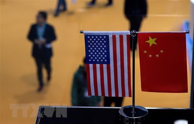Cờ Mỹ (trái) và cờ Trung Quốc (phải). (Ảnh: AFP/TTXVN).