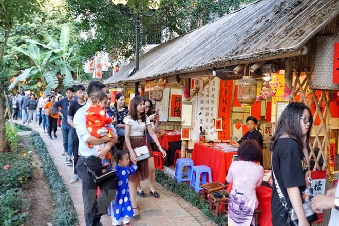 Khu vực xin chữ tại Văn Miếu-Quốc Tử Giám thu hút rất đông người dân và du khách. (Ảnh: Khánh Hòa/TTXVN phát).