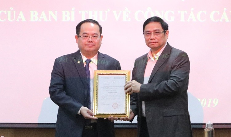 Ông Quản Minh Cường (trái) nhận quyết định làm Phó ban Tổ chức Trung ương từ ông Phạm Minh Chính. 