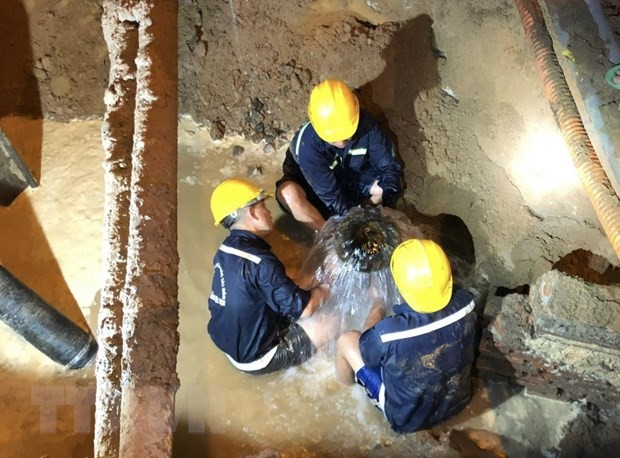 Công nhân khắc phục sự cố bể ống cấp nước D1500mm bêtông dự ứng lực trên đường Phạm Văn Đồng. (Ảnh: Anh Tuấn/TTXVN).