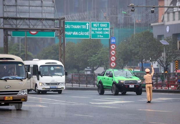 Lực lượng CGST dừng kiểm tra và xử lý xe khách vi phạm trật tự an toàn giao thông tại đường Phạm Hùng (Hà Nội). (Ảnh: Phạm Kiên/TTXVN).