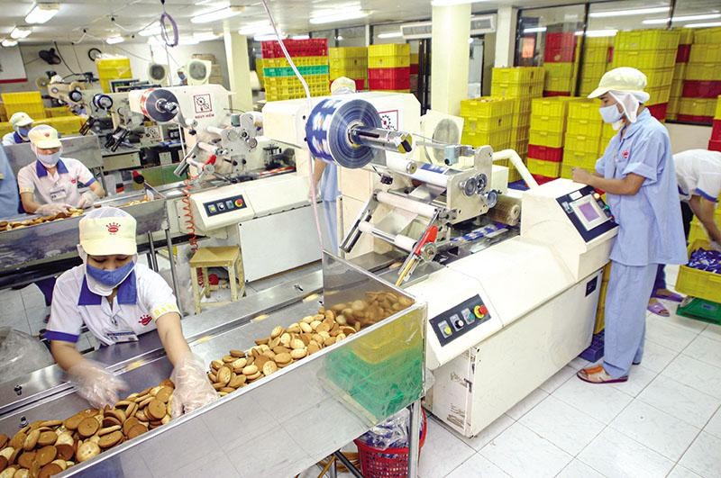 Cơ chế hậu kiểm của Nghị định 15/2018/NĐ-CP đã tiết kiệm cho doanh nghiệp ngành thực phẩm các khoản chi phí rất lớn. Trong ảnh: Sản xuất bánh tại Công ty cổ phần Tập đoàn KIDO. Ảnh: Lê Toàn